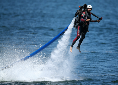 A man flying a water jet pack