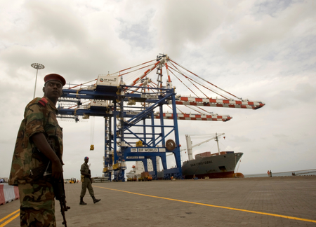 FILE PHOTO: A Djibouti policeman stands guard during the opening ceremony of Dubai-based port operator DP World&#039;s Doraleh container terminal in Djibouti port February 7, 2009.