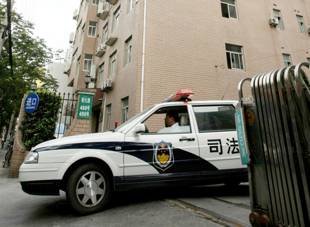 A judicial affair office car drives out at an office-apartment building where a young Canadian model Diana O&#039;Brien was found dead Wednesday, July 9, 2008 in Shanghai, China. An official in the news department of Shanghai&#039;s Public Security Bureau said that police got an emergency call early Monday about the death of O&#039;Brien. Police said Wednesday they suspect she was murdered. (AP Photo/Eugene Hoshiko