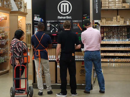 home depot employees looking at a MakerBot display