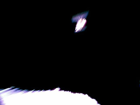 Image captured by Rover-1A on September 21 at around 13:08 JST. This is a color image taken immediately after separation from the spacecraft. Hayabusa2 is at the top and the surface of Ryugu is bottom. The image is blurred because the shot was taken while the rover was rotating.