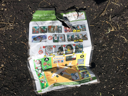 A passenger safety instruction card is seen at the scene of the Ethiopian Airlines Flight ET 302 plane crash, near the town of Bishoftu, southeast of Addis Ababa, Ethiopia March 10, 2019.