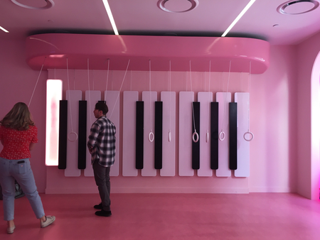 Museum of Ice Cream visitors stand in front of a giant piano