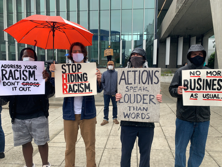 Adidas employees protesting at its Portland headquarters with signs such as &quot;Stop hiding racism&quot;
