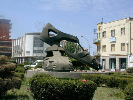 Traffic moves around a sculpture of a giant pair of sandals which has been built on a roundabout in the center of Asmara, Eritrea, Oct. 11, 2001. The sandals are the latest monument to the 30-year war Eritreans endured to win independence from neighboring Ethiopia.