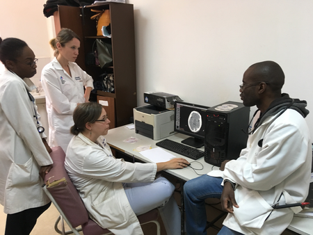 (From left) Lorraine Chishimba, Alison Navis (a visting American, Deanna Saylor and Stanley Zimba examine CT scans of UTH patients