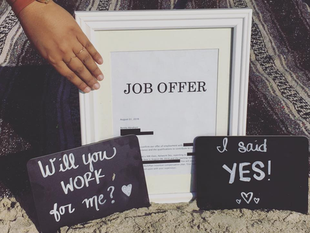 Benita Abraham shows her job offer on the beach