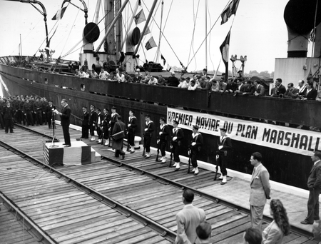 American ambassador to France, Jefferson Caffery, speaks during a ceremony at the harbor of Bordeaux, France, on May 10, 1948. The celebration is marking the arrival of the &quot;John H. Quick,&quot; carrying 8,800 tons of wheat as the first ship bringing aid to France under the Marshall Plan.