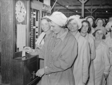 Women punching in at a munitions factory
