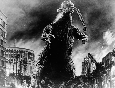 Radioactive monster Godzilla stomps through a city and eats a commuter train in a scene from &#039;Godzilla, King of the Monsters!,&#039; directed by Ishiro Honda and Terry O. Morse, 1956