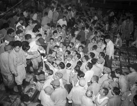 Wholesalers gather during a tuna fish auction at Tsukiji market in Tokyo, Japan, in this handout photo taken June 25, 1953 and released by Tokyo Metropolitan Government Office. Mandatory Credit Tokyo Metropolitan Government/Handout via REUTERS SEARCH &quot;TSUKIJI CLOSES&quot; FOR THIS STORY. SEARCH &quot;WIDER IMAGE&quot; FOR ALL STORIES. ATTENTION EDITORS - THIS IMAGE WAS PROVIDED BY A THIRD PARTY. MANDATORY CREDIT. NO SALES. NO ARCHIVES. - RC137C548400
