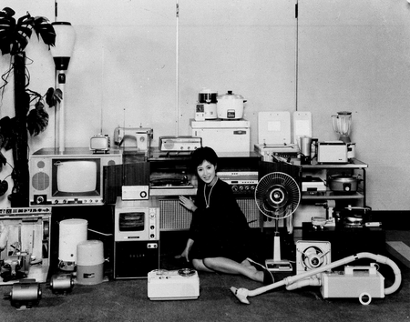 A model sits among the many different electrical appliances manufactured by the Mitsubishi Electric Co. in Japan
