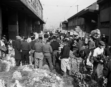 Wholesalers gather during an auction at Tsukiji market in Tokyo, Japan, in this handout photo taken March 22, 1954 and released by Tokyo Metropolitan Government Office. Mandatory Credit Tokyo Metropolitan Government/Handout via REUTERS SEARCH &quot;TSUKIJI CLOSES&quot; FOR THIS STORY. SEARCH &quot;WIDER IMAGE&quot; FOR ALL STORIES. ATTENTION EDITORS - THIS IMAGE WAS PROVIDED BY A THIRD PARTY. MANDATORY CREDIT. NO SALES. NO ARCHIVES. - RC17AF843910