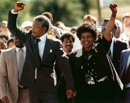FILE - In this Feb. 11, 1990 file photo, Nelson Mandela, left, and his wife Winnie, raise clenched fists as they walk hand-in-hand from the Victor Verster prison near Cape Town, South Africa. South Africans are marking the anniversary of the release of the country&#039;s first black president, Nelson Mandela, who was freed 25 years ago. Mandela was released on Feb. 11, 1990, after 27 years in prison. (AP Photo/Greg English, File)