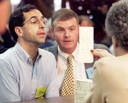 Observers David Sullivan of the Democratic party (L) and Jim Kelly of the Bush campaign (R) watch as an elections worker displays a controversial &quot;butterfly ballot&quot; to them as they are manually counted in West Palm Beach, Florida, November 11, 2000. The manual count began despite filing of a suit by the campaign of George W. Bush to stop it.