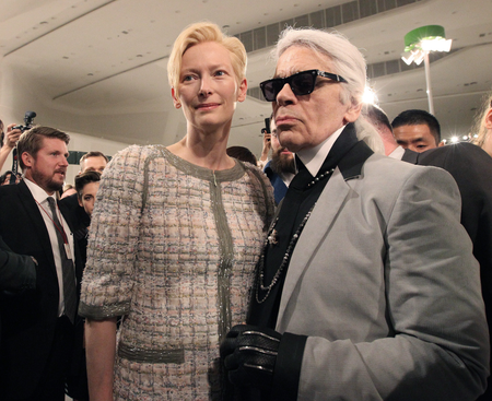 German fashion designer Karl Lagerfeld, right, poses with British actress Tilda Swinton after the presentation of his 2015-2016 Chanel cruise collection at the Dongdaemun Design Plaza in Seoul, South Korea, Monday, May 4, 2015.