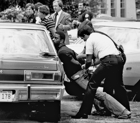 FILE - In this May 18, 1979 file photo, police handcuff a suspect during a drug raid in Miami. Police said eight were arrested and marijuana was seized. On the occasion of Legalization Day, Thursday, Dec. 6, 2012, when Washingtons new law takes effect, AP takes a look back at the cultural and legal status of the evil weed in American history. (AP Photo/Al Diaz, File)