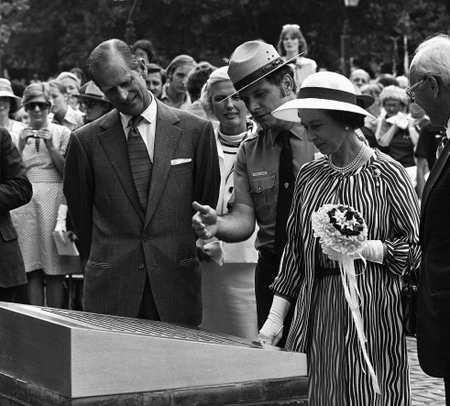 Hobart Gaywood, center, of the National Parks Service, shows a plaque describing the Bicentennial Bell, a gift of the Government of Great Britain to the United States, to Queen Elizabeth II and Prince Philip in Philadelphia on Tuesday, July 6, 1976. The Queen was here to present the bell and visited various points of interest in the area.