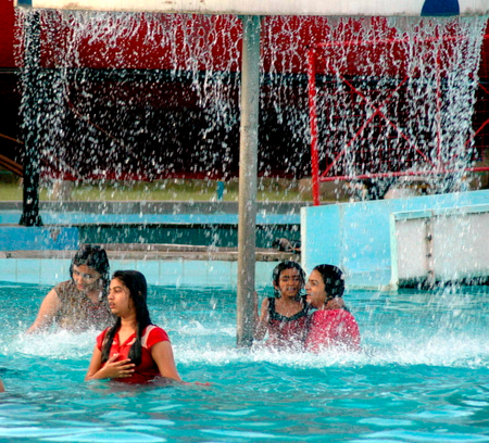 Indian women play in a water park.