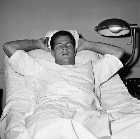 In this Nov. 22, 1960, file photo, New York Giants football player Frank Gifford lies in a bed holding an ice pack on his head at St. Elizabeth&#039;s Hospital in New York. Gifford sustained a consussion in a game on Nov. 20, 1960. The family of Pro Football Hall of Famer Frank Gifford says signs of the degenerative disease chronic traumatic encephalopathy were found in his brain after his death. In a statement released through NBC News on Wednesday, Nov. 25, 2015, the family says Gifford suffered from unspecified “cognitive and behavioral symptoms” in his later years. He died suddenly of natural causes at his Connecticut home in August at age 84. (AP Photo/File)
