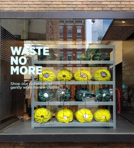 A store window with the text &quot;Waste No More&quot;