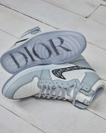 A pair of Dior Air Jordan 1s with the sole of one revealing &quot;Dior&quot; on the sole