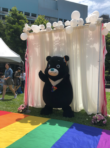 Taipei&#039;s mascot, a black bear named Bravo, alone on the rainbow aisle.