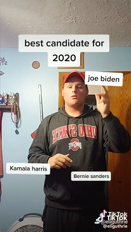 Still from a video showing man using a finger gun to shoot name of presidential candidate Joe Biden