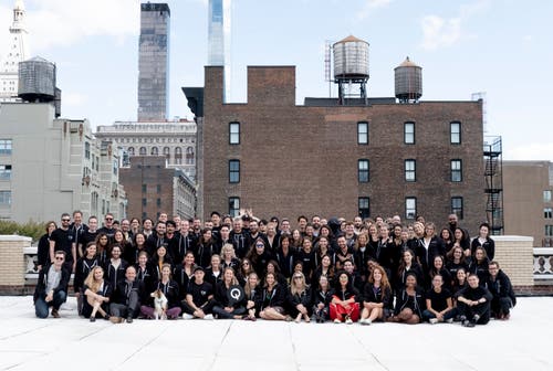 The Quartz staff pose for a class photo on the New York office rooftop