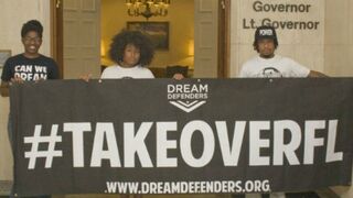 Members of the Dream Defenders protest outside Florida Gov. Rick Scott's office in July. (Mickey Adair/Getty Images)