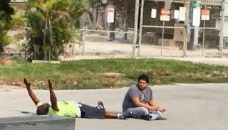 Video footage shows Charles Kinsey lying prone with his hands in the air shortly before he was shot by police in North Miami, Fla., on July 18, 2016.WPTV Screenshot