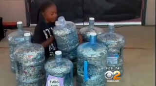 Amir Walton surrounded by jugs of tabsYouTube/CBS Los Angeles