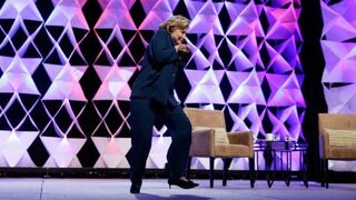 Former Secretary of State Hillary Clinton ducks to avoid a shoe thrown toward her as she speaks at the Institute of Scrap Recycling Industries Convention in Las Vegas, April 10, 2014.Isaac Brekken/Getty Images