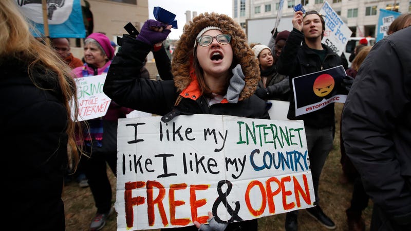Lindsay Chestnut of Baltimore holds a sign that reads “I like My Internet Like I Like my Country: Free &amp; Open” as she protests near the Federal Communications Commission (FCC), in Washington where the FCC was scheduled to meet and vote on net neutrality on Dec. 14, 2017.