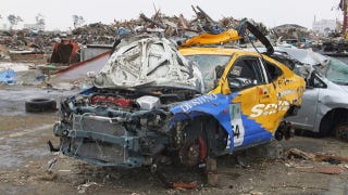 Illustration for article titled Did looters take the wheels from this Tsunami-devastated racecar?