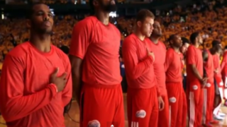 Los Angeles Clippers players stand for the national athem before Game 4 of their NBA playoff game against the Golden State Warriors April 27, 2014, wearing T-shirts turned inside out to hide the team logo in silent protest of Clippers owner Donald Sterling’s purported racist comments.Youtube