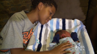 James Dukes and his little baby brother, Royal, whom James helped deliverCBS News
