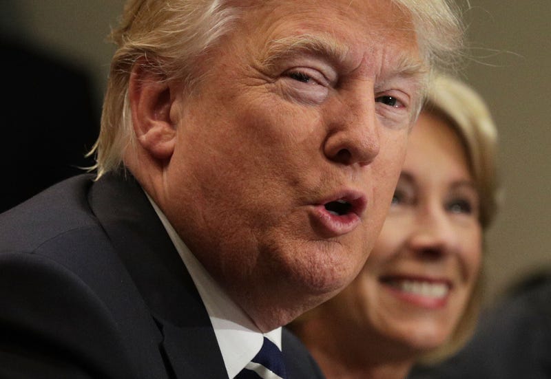 U.S. President Donald Trump speaks as Secretary of Education Betsy DeVos listens during a parent-teacher conference at the Roosevelt Room of the White House February 14, 2017 in Washington, DC. The White House held the session to discuss education.