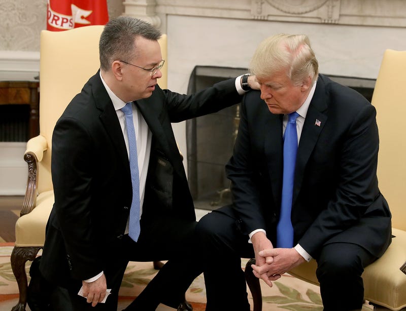 President Donald Trump and American evangelical Christian preacher Andrew Brunson (L) participate in a prayer in the Oval Office a day after Brunson was released from a Turkish jail, at the White House on October 13, 2018 in Washington, DC. Brunson was detained for two years in Turkey on espionage and terrorism-related charges that the pastor said were false.