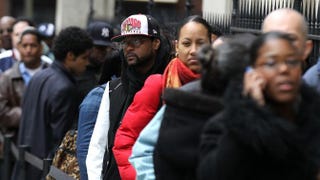 Job seekers wait in line to enter a job fair hosted by the state of New York. Justin Sullivan/Getty Images