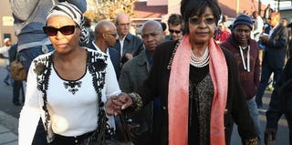 Winnie Madikizela-Mandela, right, leaves after speaking to the press outside Nelson Mandela's home. (Dan Kitwood/Getty Images)