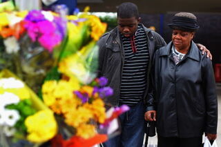 Community members lay wreaths at scene of hit-and-run after riotsin Birmingham, U.K. (Jeff J. Mitchell/Getty Images)