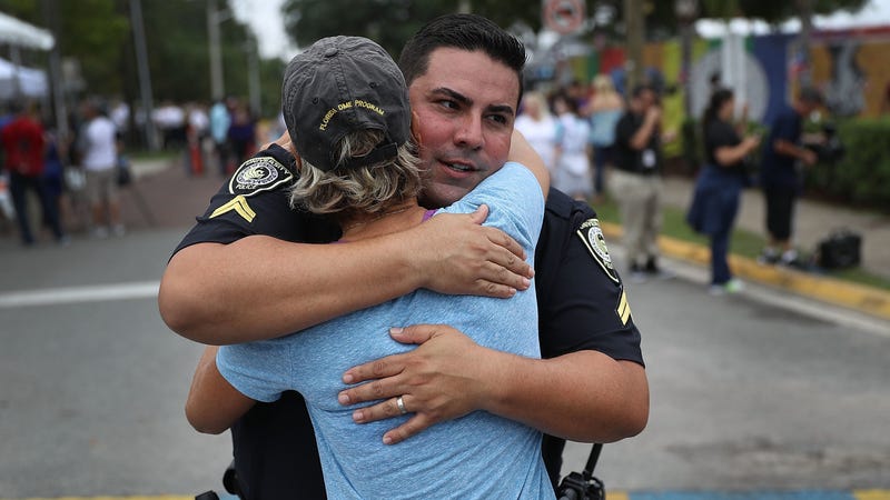 University Of Central Florida Police officer Pablo Vargas receives a hug from Christine Gigico