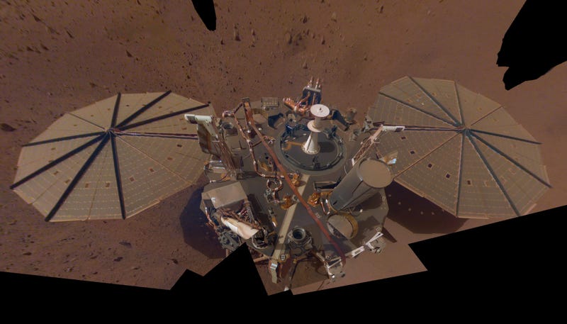 The NASA InSight lander, covered with a thin layer of reddish dust visible on the solar panels. 