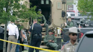 Law-enforcement officials sit at the scene of a motorcyle-gang shootout at the Twin Peaks restaurant May 18, 2015, in Waco, Texas.Erich Schlegel/Getty Images
