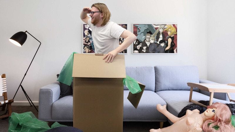 A man inside of a cardboard box.