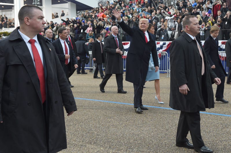Secret Service agents guard President Donald Trump and the first lady during an inauguration parade. (Timothy A Clary/Getty Images)