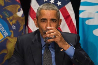 President Barack Obama drinks filtered Flint, Mich., water during a meeting at the Food Bank of Eastern Michigan in Flint on May 4, 2016. JIM WATSON/AFP/Getty Images