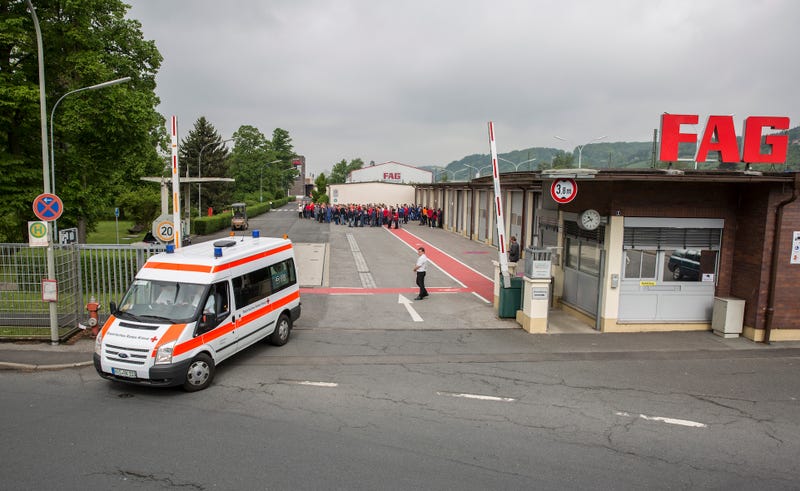 An ambulance leaves the FAG Schaeffler building on Monday morning following the explosion. Photo credit: Rene Ruprecht/dpa via AP