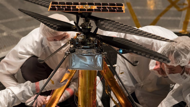 NASA engineers inspecting the Mars helicopter.
